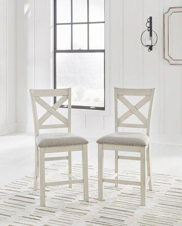 The appearance of Robbinsdale Counter Height Barstool Set of 2 In Antique White designed by Signature Design by Ashley in the transitional interior design. This antique white piece of furniture  was selected by 1StopBedrooms from Robbinsdale Collection to add a touch of cosiness and style into your home. Sku: D642-124. Material: Fabric. Product Type: Barstool. Image1