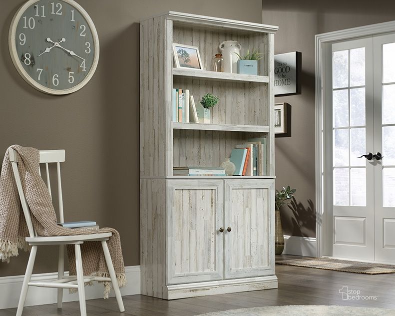 The appearance of Sauder Select Bookcase With Doors In White Plank designed by Sauder in the transitional interior design. This white plank piece of furniture  was selected by 1StopBedrooms from Sauder Select Collection to add a touch of cosiness and style into your home. Sku: 426420. Product Type: Bookcase. Material: Engineered Wood. Image1