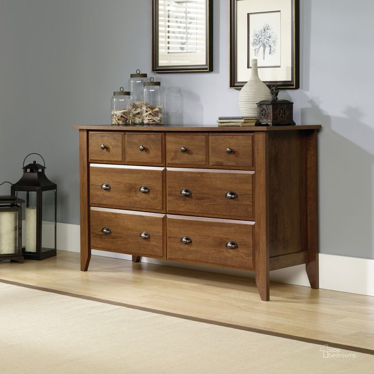 The appearance of Shoal Creek Dresser In Oiled Oak designed by Sauder in the transitional interior design. This oiled oak piece of furniture  was selected by 1StopBedrooms from Shoal Creek Collection to add a touch of cosiness and style into your home. Sku: 410287. Product Type: Dresser. Material: Engineered Wood. Image1