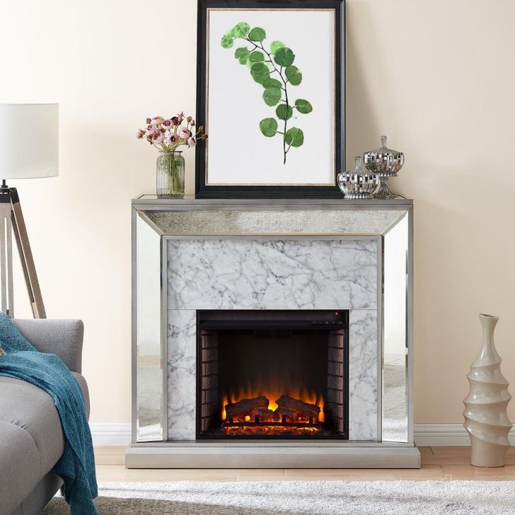 The appearance of Trandling Mirrored Faux Marble Fireplace In Antique Silver FE1027359 designed by SEI Furniture in the transitional interior design. This silver piece of furniture  was selected by 1StopBedrooms from Trandling Collection to add a touch of cosiness and style into your home. Sku: FE1027359. Material: Wood. Product Type: Fireplace. Image1