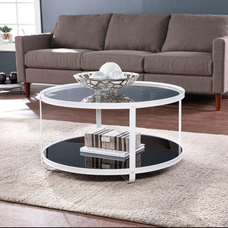 The appearance of Vimmerly Glass-Top Cocktail Table designed by SEI Furniture in the modern / contemporary interior design. This black and white piece of furniture  was selected by 1StopBedrooms from Vimmerly Collection to add a touch of cosiness and style into your home. Sku: CK1131400. Material: Glass. Product Type: Cocktail Table. Image1