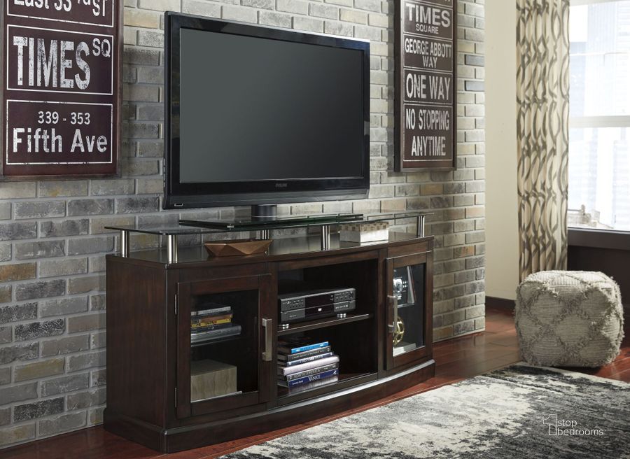 The appearance of Chanceen Dark Brown Medium TV Stand designed by Signature Design by Ashley in the modern / contemporary interior design. This dark brown piece of furniture  was selected by 1StopBedrooms from Chanceen Collection to add a touch of cosiness and style into your home. Sku: W757-48. Material: Glass. Product Type: TV Stand. Image1