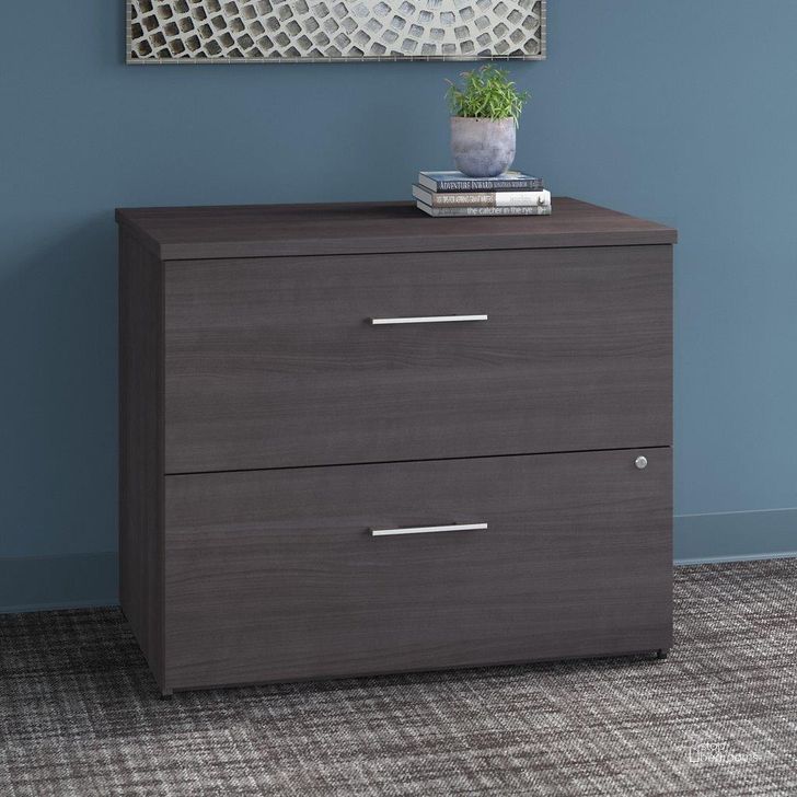 The appearance of Wreck Cove Gray Lateral Filing Cabinet 0qb24510261 designed by Luxe Linea in the modern / contemporary interior design. This gray piece of furniture  was selected by 1StopBedrooms from Wreck Cove Collection to add a touch of cosiness and style into your home. Sku: OFF136SGSU. Product Type: Lateral Filing Cabinet. Image1