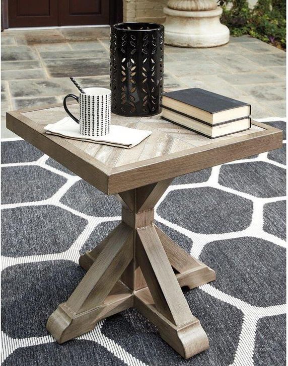 The appearance of Wyona Beige Outdoor Table 0qd2209215 designed by Isaac Tahari in the transitional interior design. This beige piece of furniture  was selected by 1StopBedrooms from Wyona Collection to add a touch of cosiness and style into your home. Sku: P791-702. Table Top Shape: Square. Material: Wood. Product Type: Outdoor Table. Image1