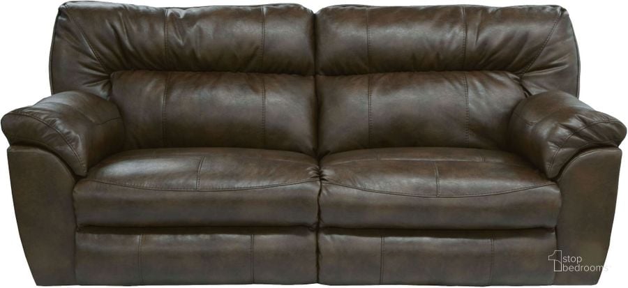 The appearance of Nolan Godiva Power Reclining Sofa designed by Catnapper in the transitional interior design. This brown piece of furniture  was selected by 1StopBedrooms from Nolan Collection to add a touch of cosiness and style into your home. Sku: 64041122329302329. Material: Bonded Leather. Product Type: Reclining Sofa. Image1
