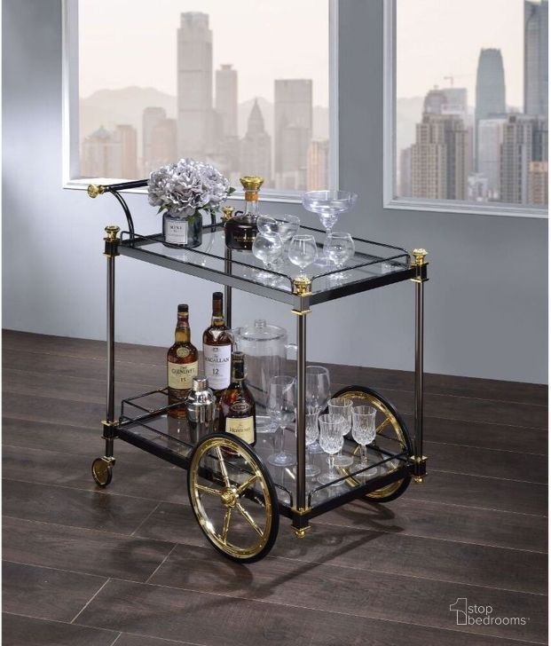 The appearance of Acme Cyrus Serving Cart In Black And Gold designed by ACME in the transitional interior design. This black and gold piece of furniture  was selected by 1StopBedrooms from Cyrus Collection to add a touch of cosiness and style into your home. Sku: 98370. Material: Metal. Product Type: Serving Cart. Image1