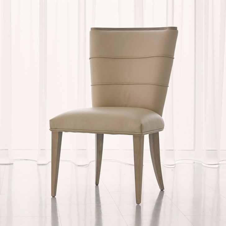 The appearance of Adelaide Side Dining Chair In Beige designed by Global Views in the modern / contemporary interior design. This white piece of furniture  was selected by 1StopBedrooms from Adelaide Collection to add a touch of cosiness and style into your home. Sku: 7.20094. Material: Wood. Product Type: Dining Chair. Image1