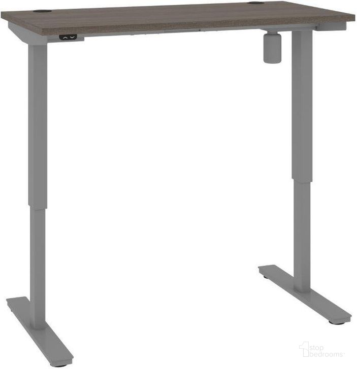 The appearance of Bestar Upstand Standing Desk In Bark Grey 175859-000047 designed by Bestar in the modern / contemporary interior design. This grey piece of furniture  was selected by 1StopBedrooms from Upstand Collection to add a touch of cosiness and style into your home. Sku: 175859-000047. Material: Wood. Product Type: Desk. Image1