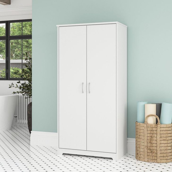 The appearance of Bush Furniture Cabot Tall Bathroom Storage Cabinet with Doors in White designed by Bush Furniture in the modern / contemporary interior design. This white piece of furniture  was selected by 1StopBedrooms from Cabot Collection to add a touch of cosiness and style into your home. Sku: WC31999-Z1. Product Type: Bathroom Storage. Image1