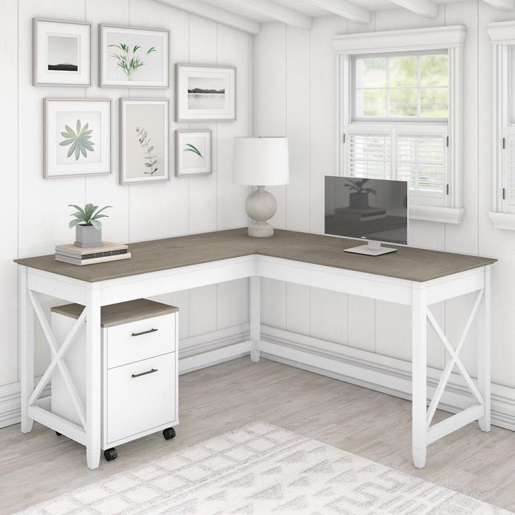 The appearance of Bush Furniture Key West 60W L Shaped Desk With 2 Drawer Mobile File Cabinet In Pure White And Shiplap Gray designed by Bush Furniture in the country / farmhouse interior design. This white and gray piece of furniture  was selected by 1StopBedrooms from Key West Collection to add a touch of cosiness and style into your home. Sku: KWS013G2W. Product Type: Home Office Desk. Image1
