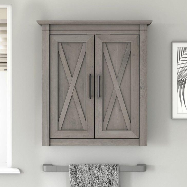 The appearance of Bush Furniture Key West Bathroom Wall Cabinet with Doors in Driftwood Gray designed by Bush Furniture in the country / farmhouse interior design. This gray piece of furniture  was selected by 1StopBedrooms from Key West Bathroom Collection to add a touch of cosiness and style into your home. Sku: KWWS124DG-03. Product Type: Bathroom Storage. Image1
