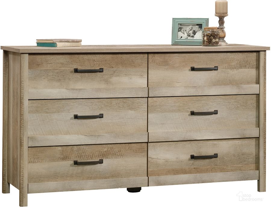 The appearance of Cannery Bridge Dresser In Lintel Oak designed by Sauder in the country / farmhouse interior design. This lintel oak piece of furniture  was selected by 1StopBedrooms from Cannery Bridge Collection to add a touch of cosiness and style into your home. Sku: 419884. Product Type: Dresser. Material: Engineered Wood. Image1