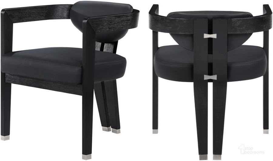 The appearance of Carlyle Vegan Leather Dining Chair In Black designed by Meridian in the modern / contemporary interior design. This black piece of furniture  was selected by 1StopBedrooms from Carlyle Collection to add a touch of cosiness and style into your home. Sku: 563Black-C. Product Type: Dining Chair. Material: Rubberwood. Image1