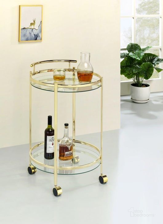 The appearance of Chrissy Round Glass Bar Cart Brass designed by Coaster in the modern / contemporary interior design. This brass piece of furniture  was selected by 1StopBedrooms from Chrissy Collection to add a touch of cosiness and style into your home. Sku: 181366. Material: Glass. Product Type: Bar Cart. Image1