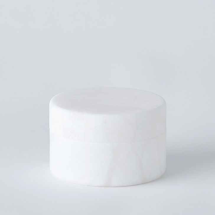 The appearance of Cilindro Alabaster Small Box In White designed by Global Views in the modern / contemporary interior design. This white piece of furniture  was selected by 1StopBedrooms from Cilindro Collection to add a touch of cosiness and style into your home. Sku: 7.3023. Product Type: Box. Material: Alabaster. Image1