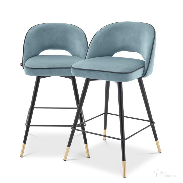 The appearance of Counter Stool In Cliff Savona Blue Velvet Set Of 2 designed by Eichholtz in the modern / contemporary interior design. This blue piece of furniture  was selected by 1StopBedrooms from Cliff Collection to add a touch of cosiness and style into your home. Sku: A114323. Material: Leather. Product Type: Barstool. Image1