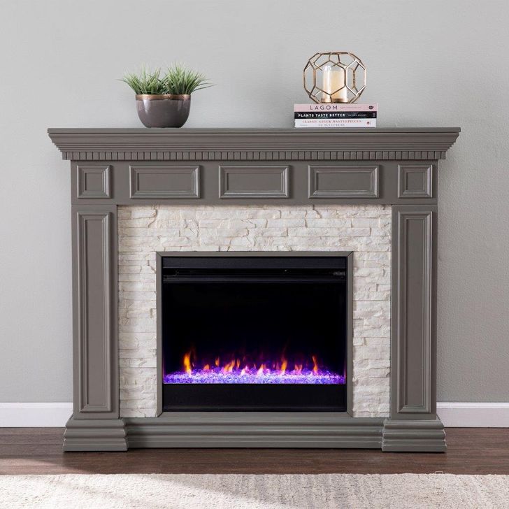 The appearance of Dakesbury Color Changing Fireplace With Faux Stone designed by SEI Furniture in the traditional interior design. This grey piece of furniture  was selected by 1StopBedrooms from Dakesbury Collection to add a touch of cosiness and style into your home. Sku: FC1095959. Material: Wood. Product Type: Fireplace. Image1