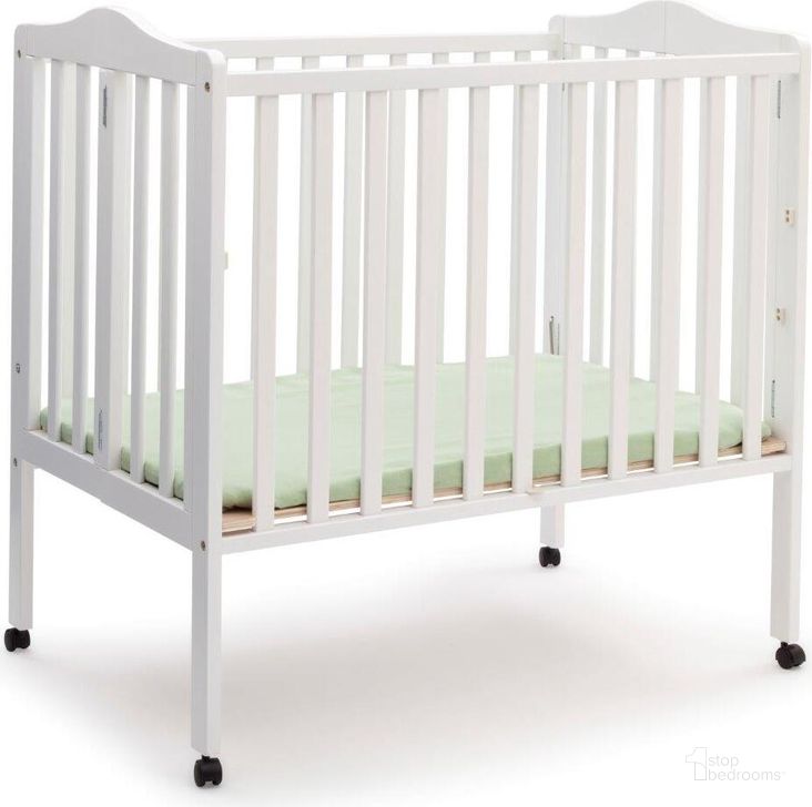 The appearance of Delta Children Folding Portable Mini Baby Crib With 1.5 Inch Mattress With Greenguard Gold Certified In White designed by Delta Children in the modern / contemporary interior design. This white piece of furniture  was selected by 1StopBedrooms from  to add a touch of cosiness and style into your home. Sku: 4470-100. Material: Wood. Product Type: Crib. Image1
