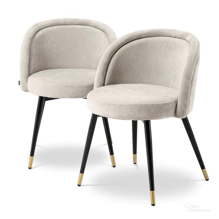 The appearance of Dining Chair Chloe Clarck Sand Set Of 2 designed by Eichholtz in the modern / contemporary interior design. This sand piece of furniture  was selected by 1StopBedrooms from Chloe Collection to add a touch of cosiness and style into your home. Sku: A114859. Product Type: Dining Chair. Material: Brass. Image1