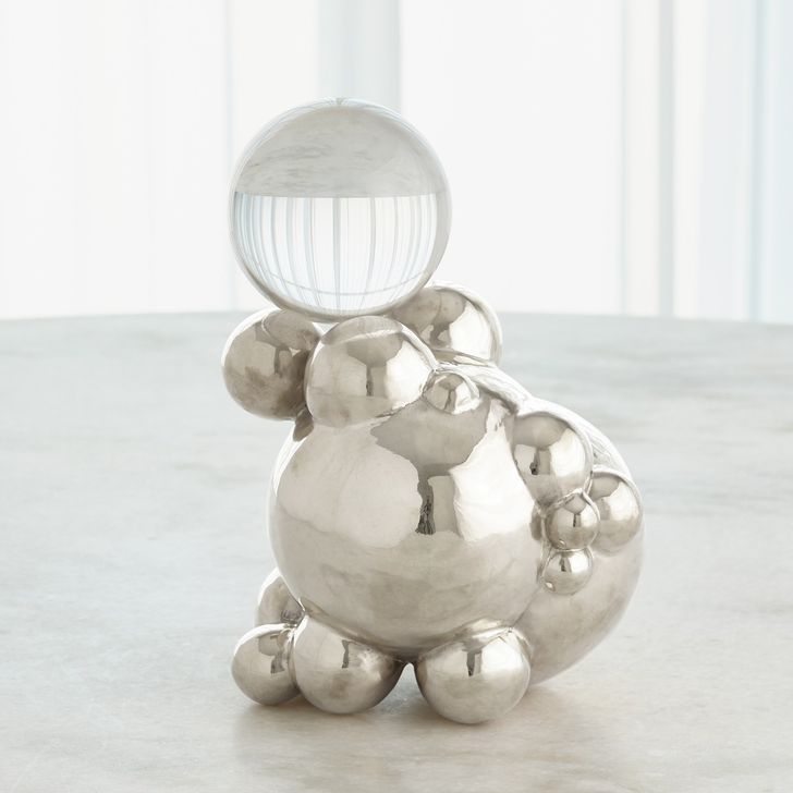 The appearance of Large Bubble Orb Holder In Nickel With Crystal Sphere designed by Global Views in the modern / contemporary interior design. This clear piece of furniture  was selected by 1StopBedrooms from Bubble Collection to add a touch of cosiness and style into your home. Sku: 8.83071. Product Type: Decorative Accessory. Material: Brass. Image1