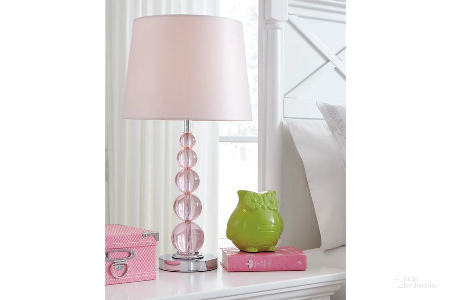 The appearance of Letty Pink Crystal Table Lamp designed by Signature Design by Ashley in the transitional interior design. This pink piece of furniture  was selected by 1StopBedrooms from Letty Collection to add a touch of cosiness and style into your home. Sku: L857664. Material: Other. Product Type: Table Lamp. Image1