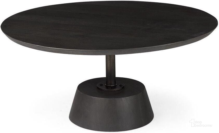 The appearance of Maxwell Dark Brown Wood With Black Metal Pedestal Base Round Coffee Table designed by Mercana in the modern / contemporary interior design. This dark brown and black piece of furniture  was selected by 1StopBedrooms from Maxwell Collection to add a touch of cosiness and style into your home. Sku: 69202. Material: Wood. Product Type: Coffee Table. Image1