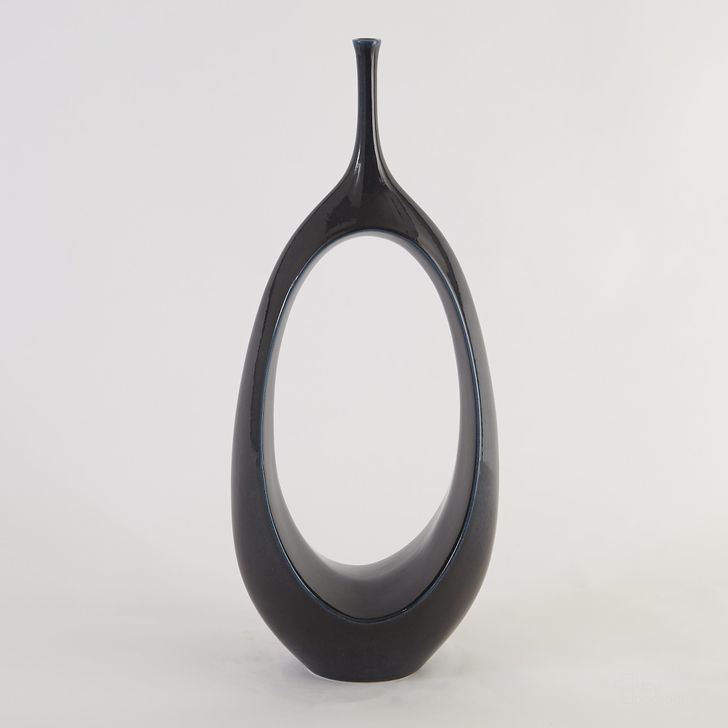 The appearance of Open Oval Ring Small Vase In Celestial designed by Global Views in the modern / contemporary interior design. This black piece of furniture  was selected by 1StopBedrooms from Open Collection to add a touch of cosiness and style into your home. Sku: 1.10051. Material: Ceramic. Product Type: Vase. Image1