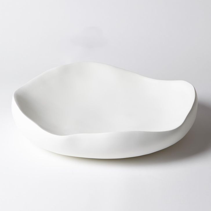 The appearance of Organic Round Large Bowl In Matte White designed by Global Views in the modern / contemporary interior design. This white piece of furniture  was selected by 1StopBedrooms from Organic Collection to add a touch of cosiness and style into your home. Sku: 3.31436. Material: Ceramic. Product Type: Bowl. Image1