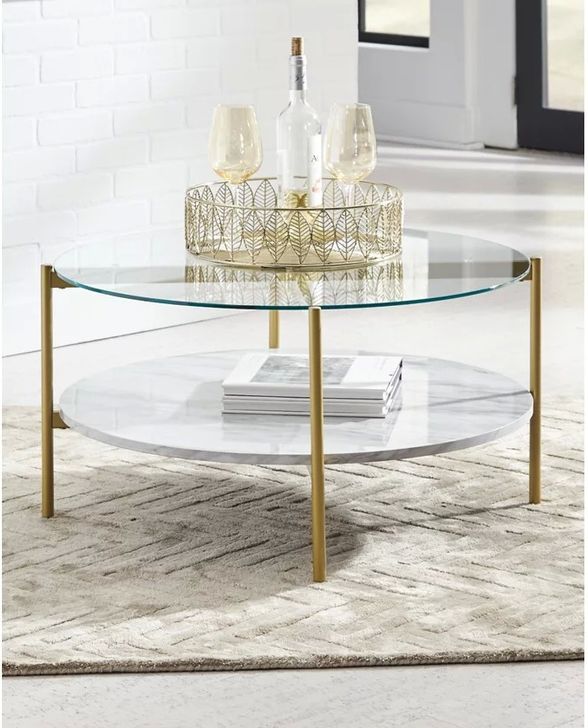 The appearance of Pipers Cove White/Gold Coffee and Cocktail Table designed by Isaac Tahari in the transitional interior design. This white/gold piece of furniture  was selected by 1StopBedrooms from Pipers Cove Collection to add a touch of cosiness and style into your home. Sku: T192-8. Material: Glass. Product Type: Coffee and Cocktail Table. Image1