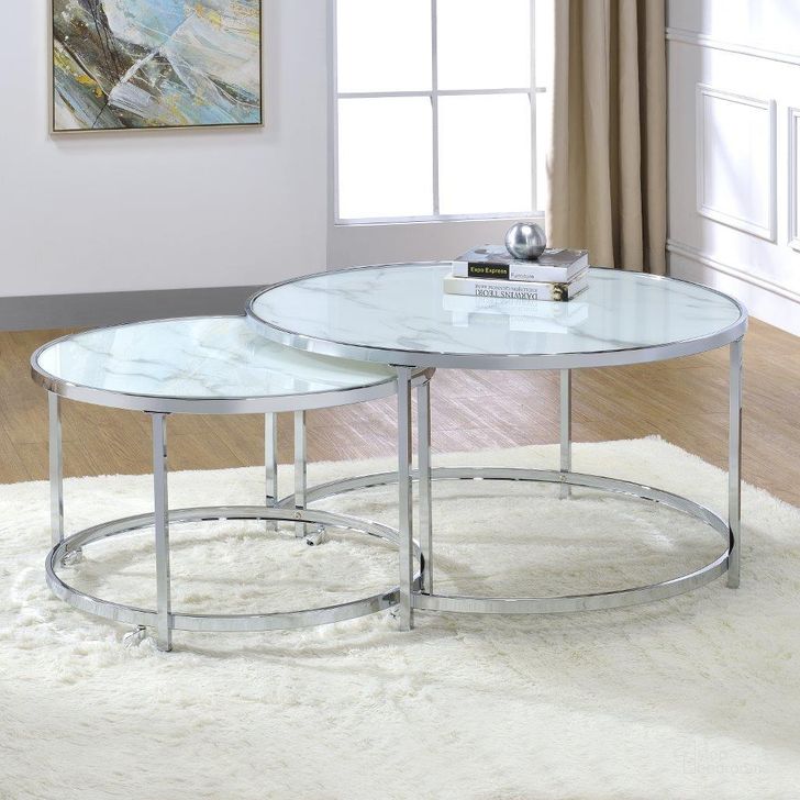 The appearance of Rayne Nesting Cocktail Tables In White designed by Steve Silver in the modern / contemporary interior design. This white piece of furniture  was selected by 1StopBedrooms from Rayne Collection to add a touch of cosiness and style into your home. Sku: RY300NCW. Material: Faux Marble. Product Type: Cocktail Table. Image1
