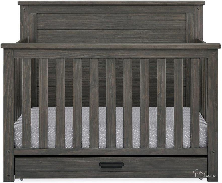 The appearance of Simmons Kids Caden 6 In 1 Convertible Crib With Trundle Drawer With Greenguard Gold Certified In Rustic Grey designed by Delta Children in the country / farmhouse interior design. This rustic gray piece of furniture  was selected by 1StopBedrooms from Caden Collection to add a touch of cosiness and style into your home. Sku: W348150-084. Material: Wood. Product Type: Crib. Image1