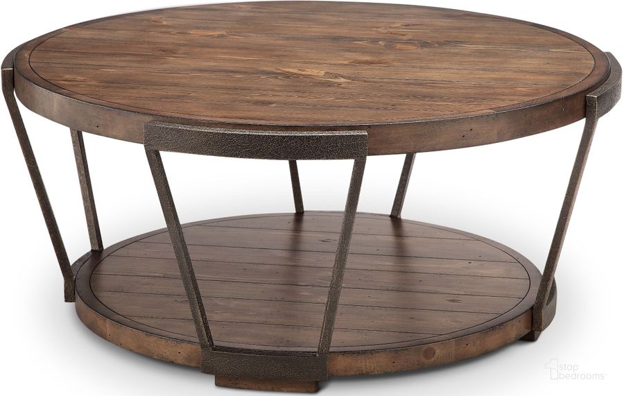 The appearance of Yukon Bourbon and Aged Iron Round Cocktail Table designed by Magnussen in the transitional interior design. This brown piece of furniture  was selected by 1StopBedrooms from Yukon Collection to add a touch of cosiness and style into your home. Sku: T4405-45. Table Top Shape: Round. Material: Wood. Product Type: Cocktail Table. Image1