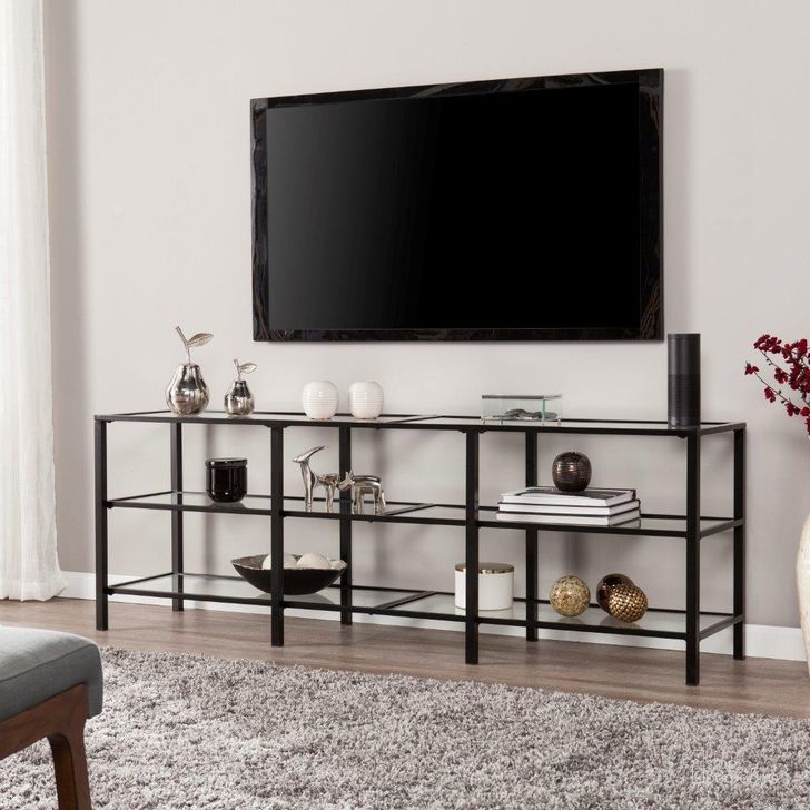 The appearance of Tyler Metal-Glass Transitional Style Tv Stand In Black designed by SEI Furniture in the modern / contemporary interior design. This matte black piece of furniture  was selected by 1StopBedrooms from Tyler Collection to add a touch of cosiness and style into your home. Sku: MS2451. Product Type: TV Stand. Material: Iron. Image1