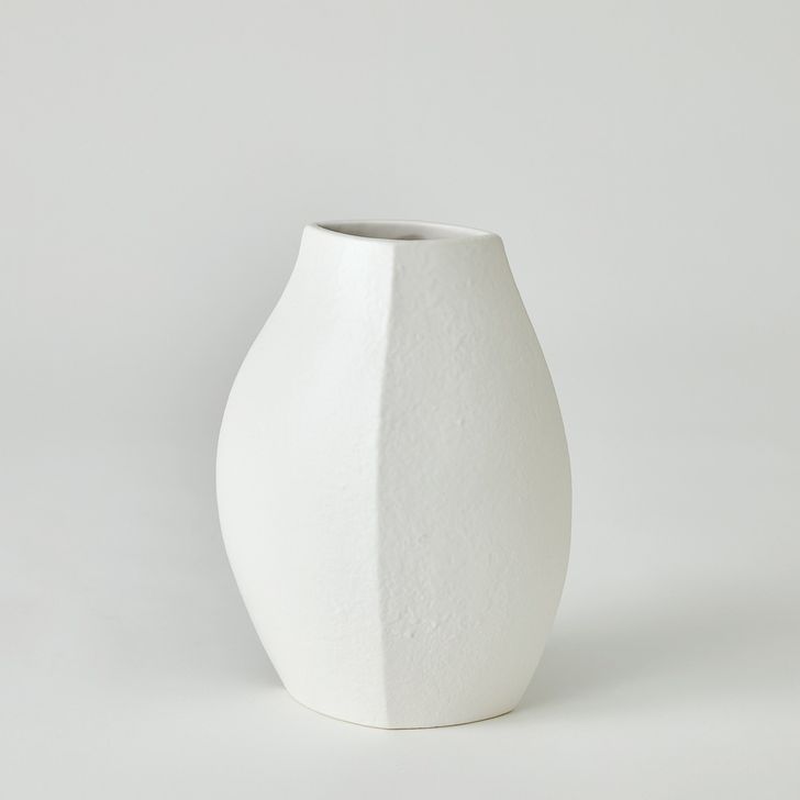 The appearance of Wedge Small Vase In White designed by Global Views in the modern / contemporary interior design. This white piece of furniture  was selected by 1StopBedrooms from Wedge Collection to add a touch of cosiness and style into your home. Sku: 7.10543. Material: Ceramic. Product Type: Vase. Image1