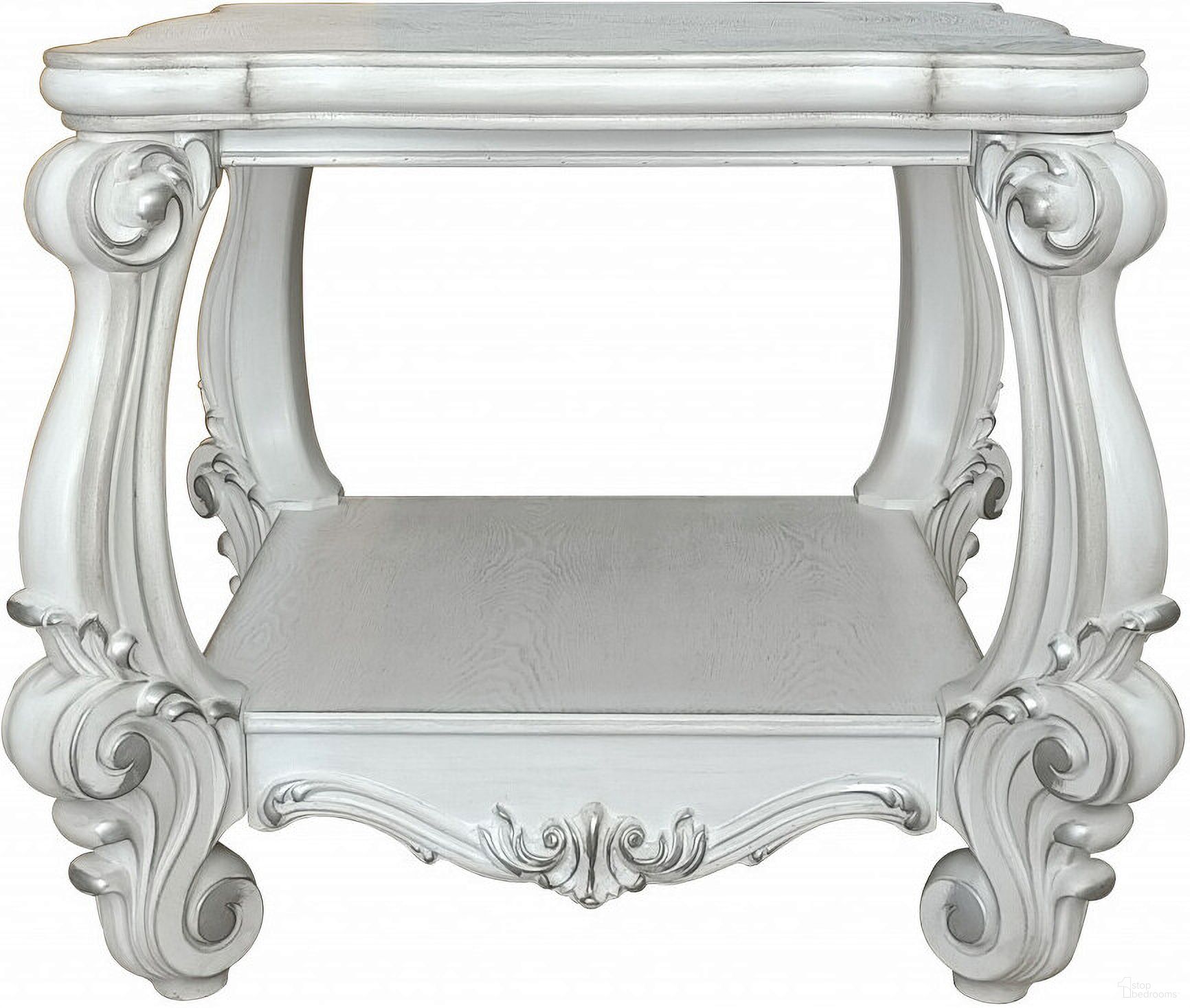 The appearance of 26 Inch Manufactured Wood Square Scroll End Table with Shelf In Antiqued White designed by Homeroots in the traditional interior design. This antiqued white piece of furniture  was selected by 1StopBedrooms from  to add a touch of cosiness and style into your home. Sku: 485838. Material: Wood.