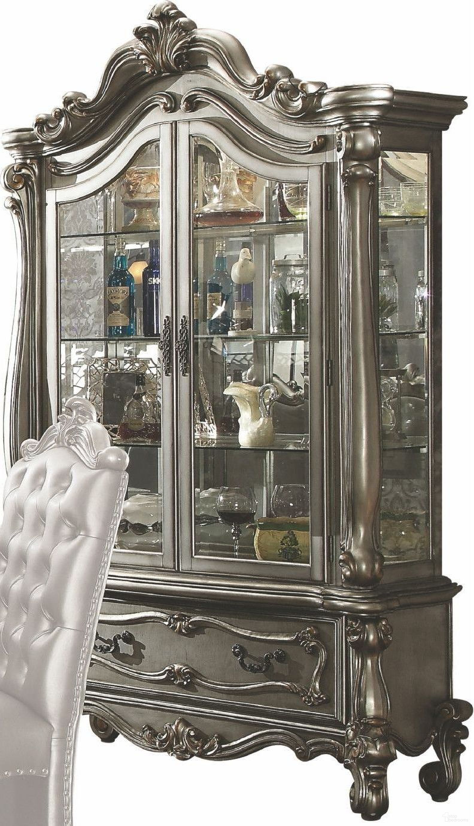 The appearance of Versailles Antique Platinum Curio Cabinet designed by ACME in the rustic / southwestern interior design. This silver piece of furniture was selected by 1StopBedrooms from Versailles Collection to add a touch of cosiness and style into your home. Sku: 66838H;66839B. Material: Wood.