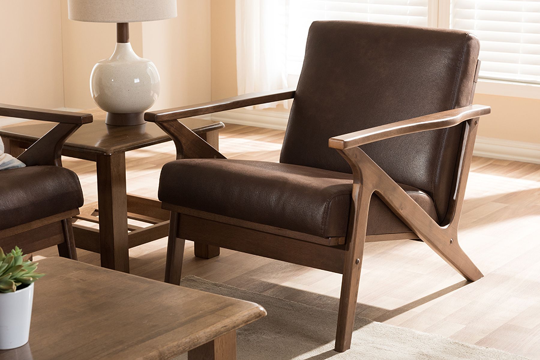 The appearance of Baxton Studio Bianca Mid-Century Modern Walnut Wood Dark Brown Distressed Faux Leather Lounge Chair designed by Baxton Studio in the transitional interior design. This dark brown piece of furniture was selected by 1StopBedrooms from Bianca Collection to add a touch of cosiness and style into your home. Sku: Bianca-Dark Brown/Walnut Brown-CC. Material: Faux Leather.