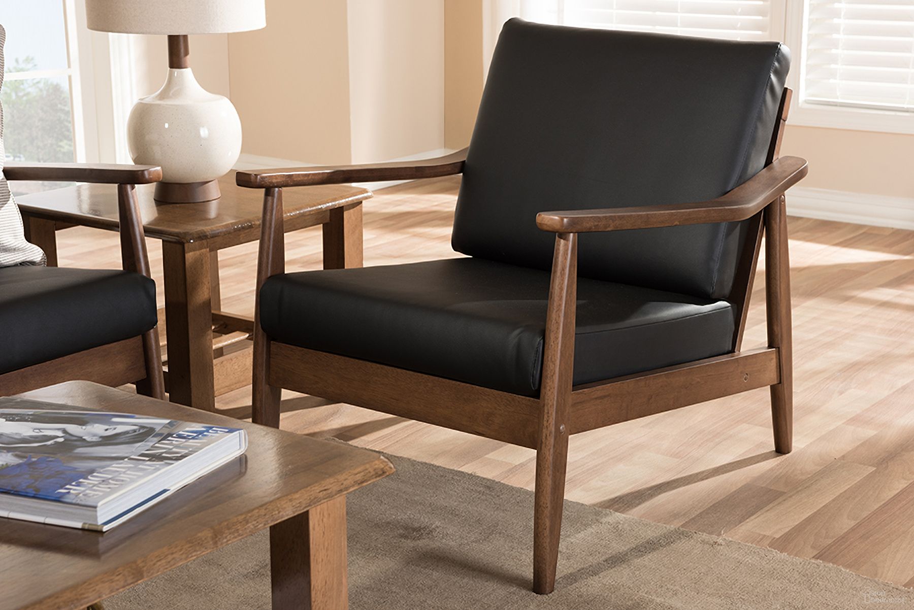 The appearance of Baxton Studio Venza Mid-Century Modern Walnut Wood Black Faux Leather Lounge Chair designed by Baxton Studio in the transitional interior design. This black piece of furniture was selected by 1StopBedrooms from Venza Collection to add a touch of cosiness and style into your home. Sku: Venza-Black/Walnut Brown-CC. Material: Faux Leather.