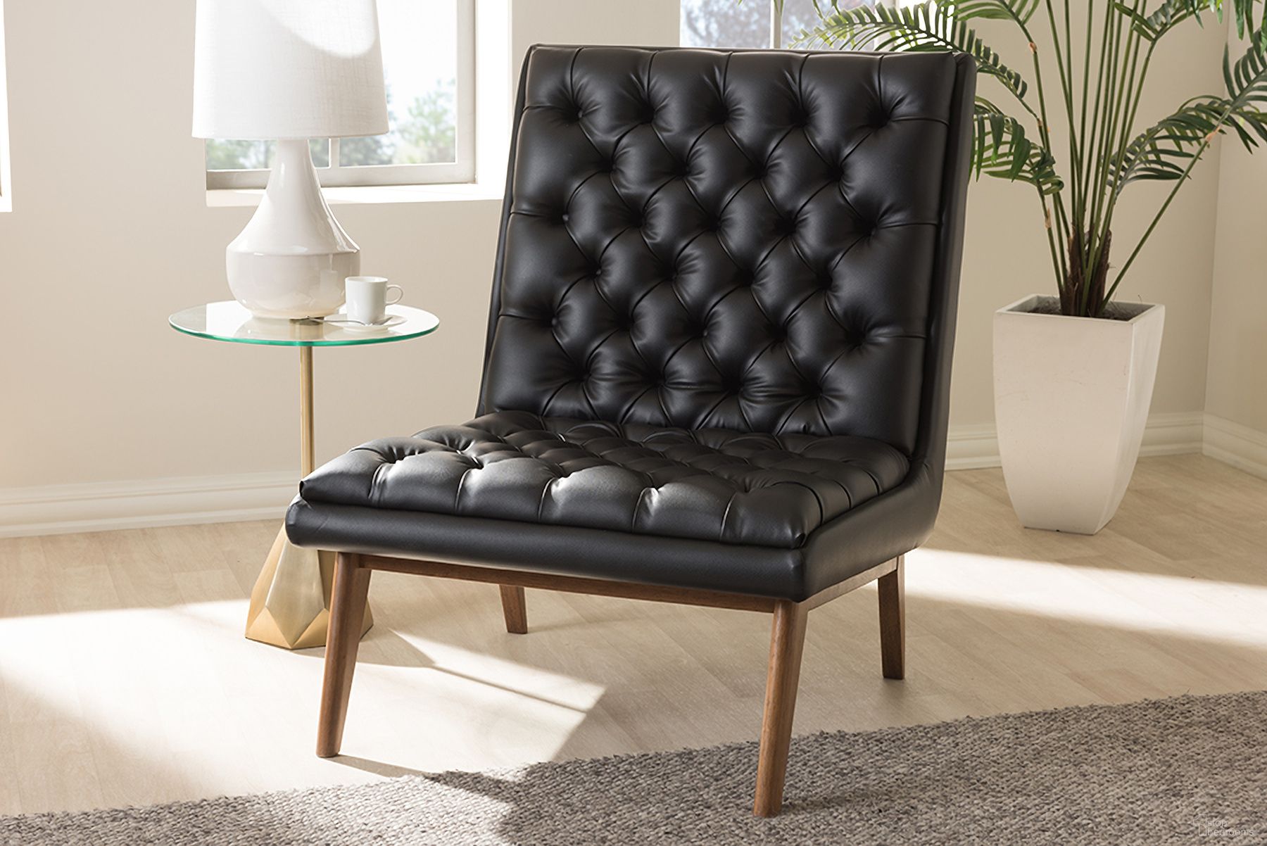 The appearance of Baxton Studio Annetha Mid-Century Modern Black Faux Leather Upholstered Walnut Finished Wood Lounge Chair designed by Baxton Studio in the transitional interior design. This black piece of furniture  was selected by 1StopBedrooms from Annetha Collection to add a touch of cosiness and style into your home. Sku: BBT5272-Pine Black-CC. Material: Leather.
