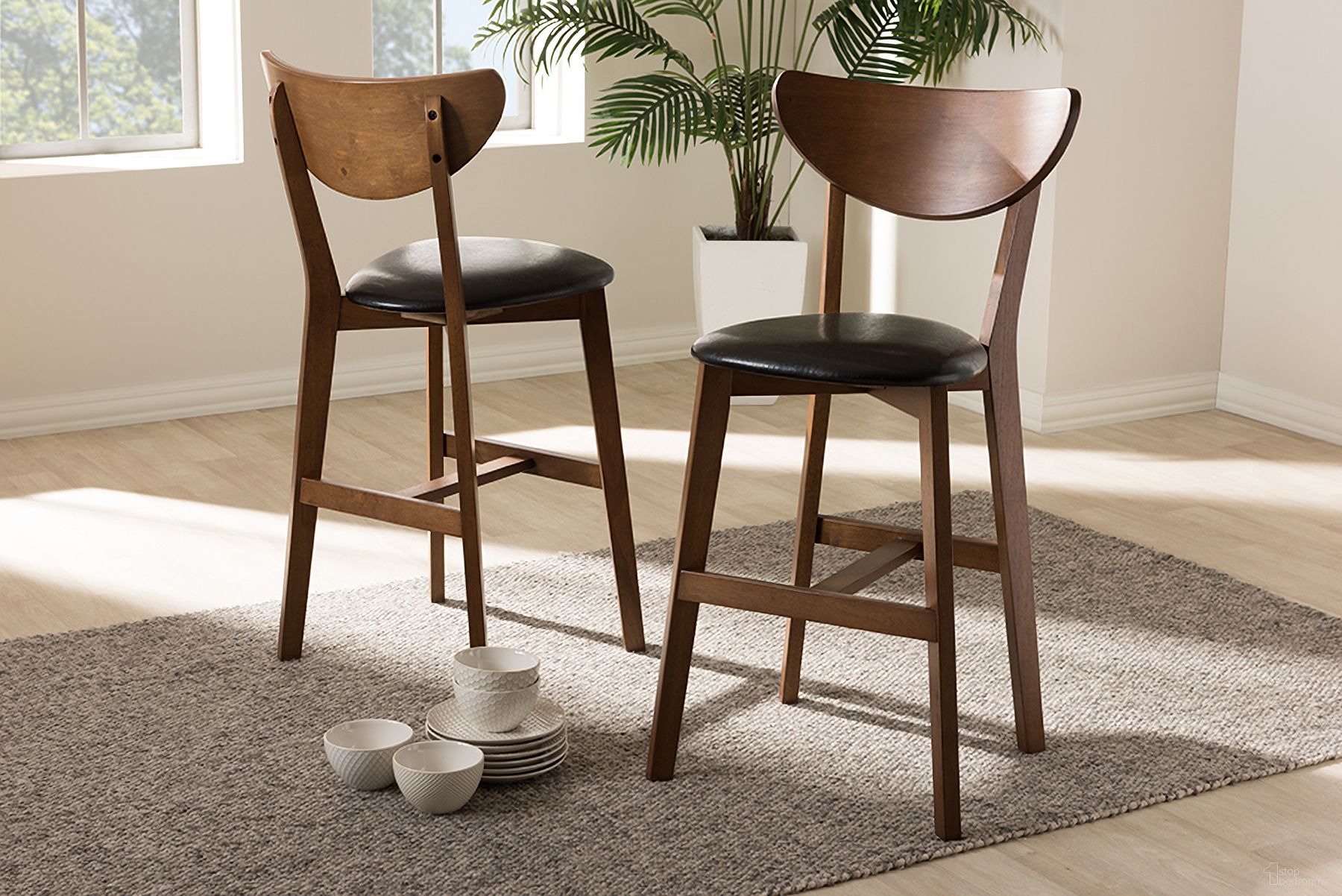 The appearance of Baxton Studio Eline Mid-Century Modern Black Faux Leather Upholstered Walnut Finished Counter Stool (Set Of 2) designed by Baxton Studio in the transitional interior design. This black piece of furniture was selected by 1StopBedrooms from Eline Collection to add a touch of cosiness and style into your home. Sku: Leena-Black/Walnut-Counter Stool. Material: Rubberwood.
