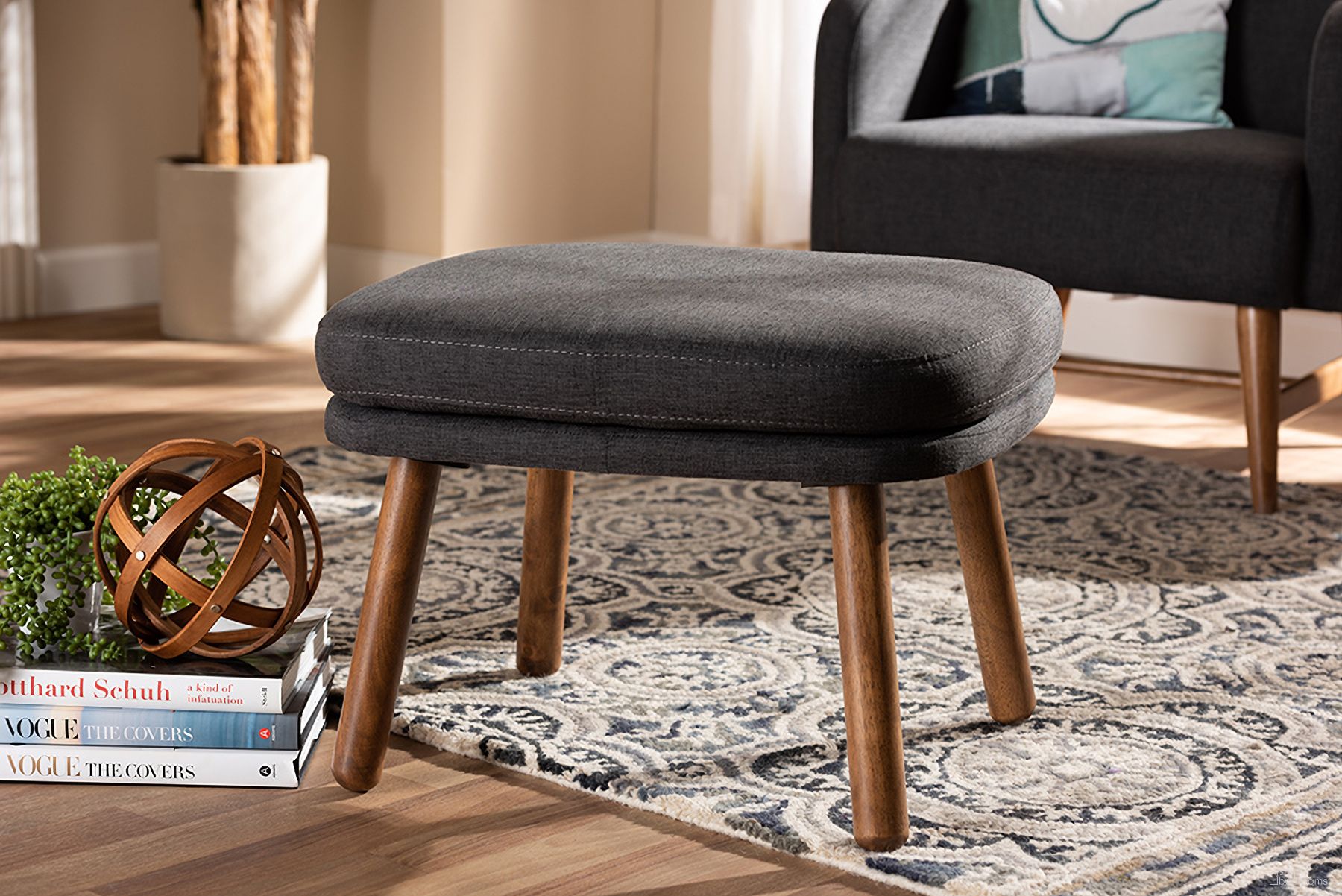 The appearance of Baxton Studio Lovise Mid-Century Modern Dark Grey Fabric Upholstered Walnut Brown Finished Wood Ottoman designed by Baxton Studio in the transitional interior design. This dark grey piece of furniture was selected by 1StopBedrooms from Lovise Collection to add a touch of cosiness and style into your home. Sku: BBT5342-Dark Grey. Material: Polyester.