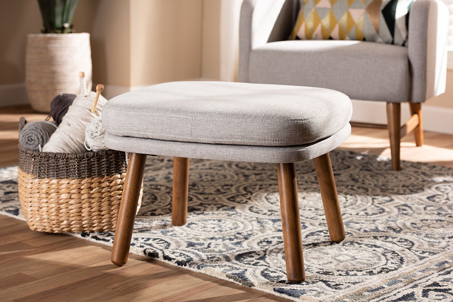 The appearance of Baxton Studio Lovise Mid-Century Modern Greyish Beige Fabric Upholstered Walnut Brown Finished Wood Ottoman designed by Baxton Studio in the transitional interior design. This beige piece of furniture was selected by 1StopBedrooms from Lovise Collection to add a touch of cosiness and style into your home. Sku: BBT5342-Greyish Beige. Material: Polyester.