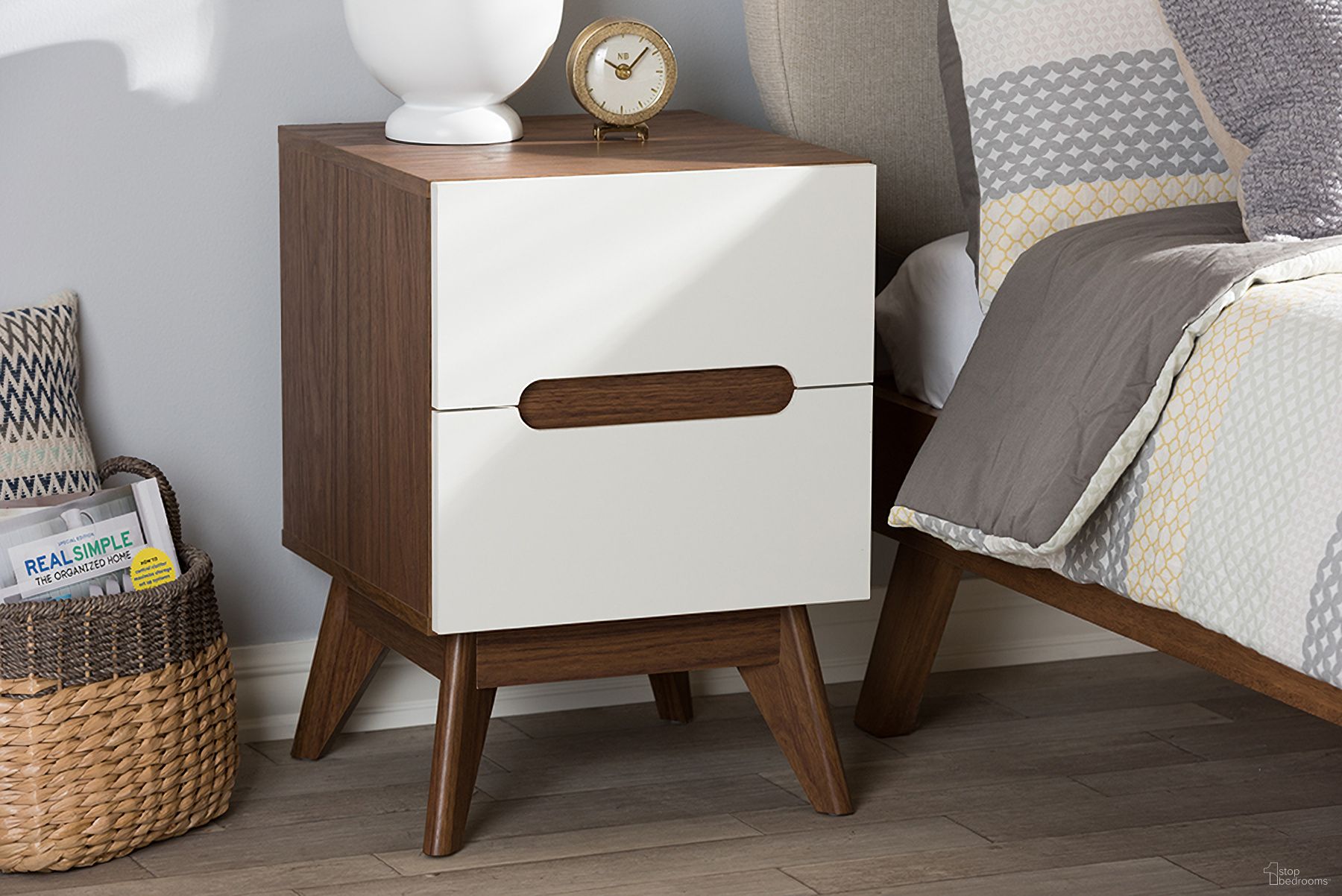 The appearance of Baxton Studio Calypso Mid-Century Modern White and Walnut Wood 2-Drawer Storage Nightstand designed by Baxton Studio in the transitional interior design. This white piece of furniture  was selected by 1StopBedrooms from Calypso Collection to add a touch of cosiness and style into your home. Sku: Calypso-Walnut/White-NS. Material: Particle Board.