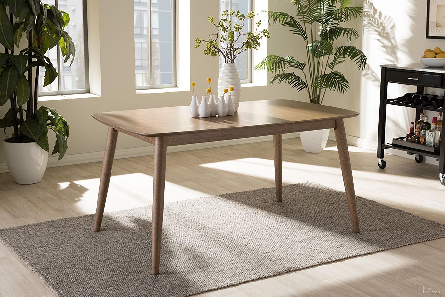 The appearance of Baxton Studio Edna Mid-Century Modern French Oak Light Brown Finishing Wood Dining Table designed by Baxton Studio in the transitional interior design. This oak piece of furniture  was selected by 1StopBedrooms from Edna Collection to add a touch of cosiness and style into your home. Sku: Flora-French Oak-DT. Table Base Style: Legs. Table Top Shape: Rectangular. Material: Rubberwood. Size: 59" x 35".