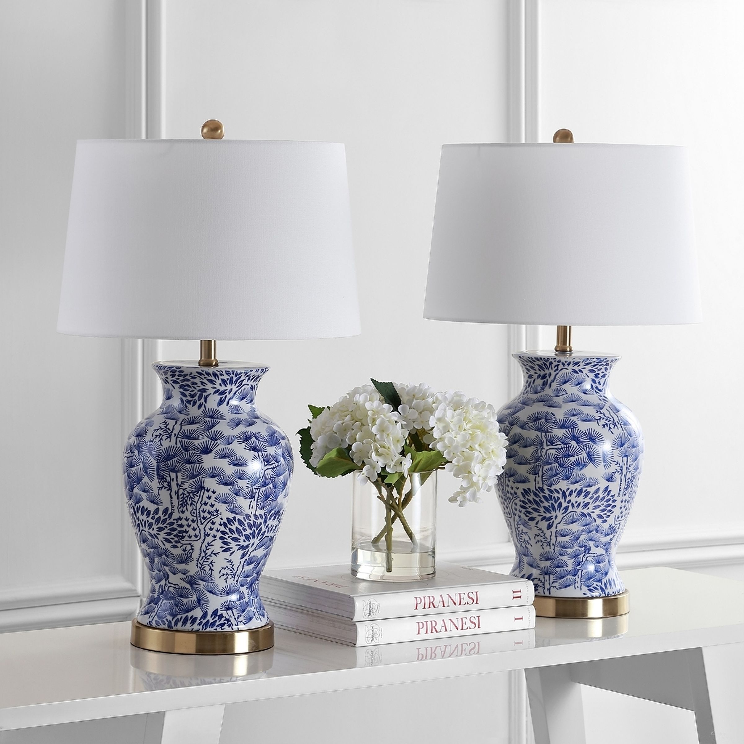 The appearance of Alona Blue and White Table Lamp Set of 2 designed by Safavieh in the modern / contemporary interior design. This blue and white piece of furniture  was selected by 1StopBedrooms from Safavieh TBL Collection to add a touch of cosiness and style into your home. Sku: TBL4162A-SET2. Material: Brass.