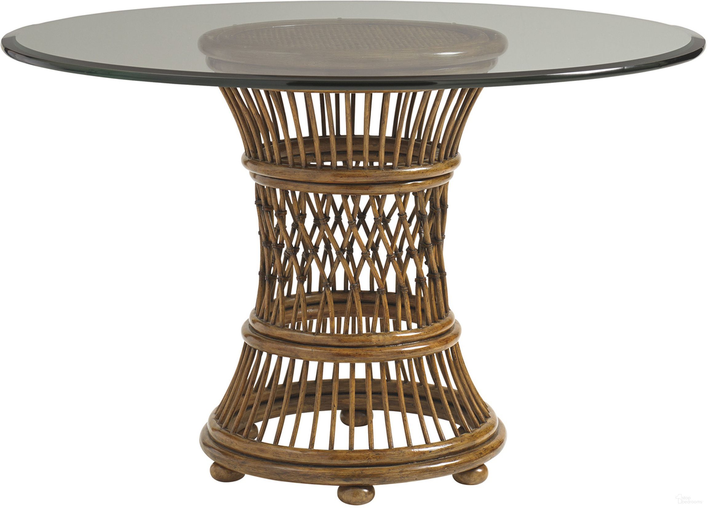 The appearance of Bali Hai Aruba Dining Table with 48 Inch Glass Top In Sunset designed by Tommy Bahama in the transitional interior design. This sunset piece of furniture  was selected by 1StopBedrooms from Bali Hai Collection to add a touch of cosiness and style into your home. Sku: 593-870-48C. Table Base Style: Pedestal. Table Top Shape: Round. Material: Rattan. Size: 48".