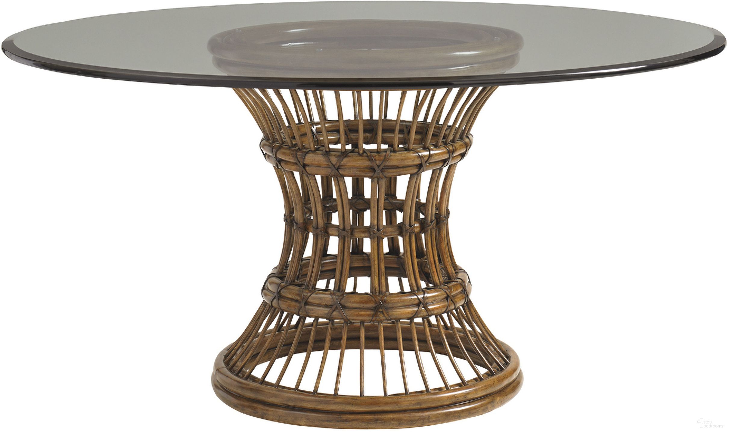 The appearance of Bali Hai Latitude Dining Table with 60 Inch Glass Top In Sunset designed by Tommy Bahama in the transitional interior design. This sunset piece of furniture  was selected by 1StopBedrooms from Bali Hai Collection to add a touch of cosiness and style into your home. Sku: 593-875-60C. Table Base Style: Pedestal. Table Top Shape: Round. Material: Rattan. Size: 60".