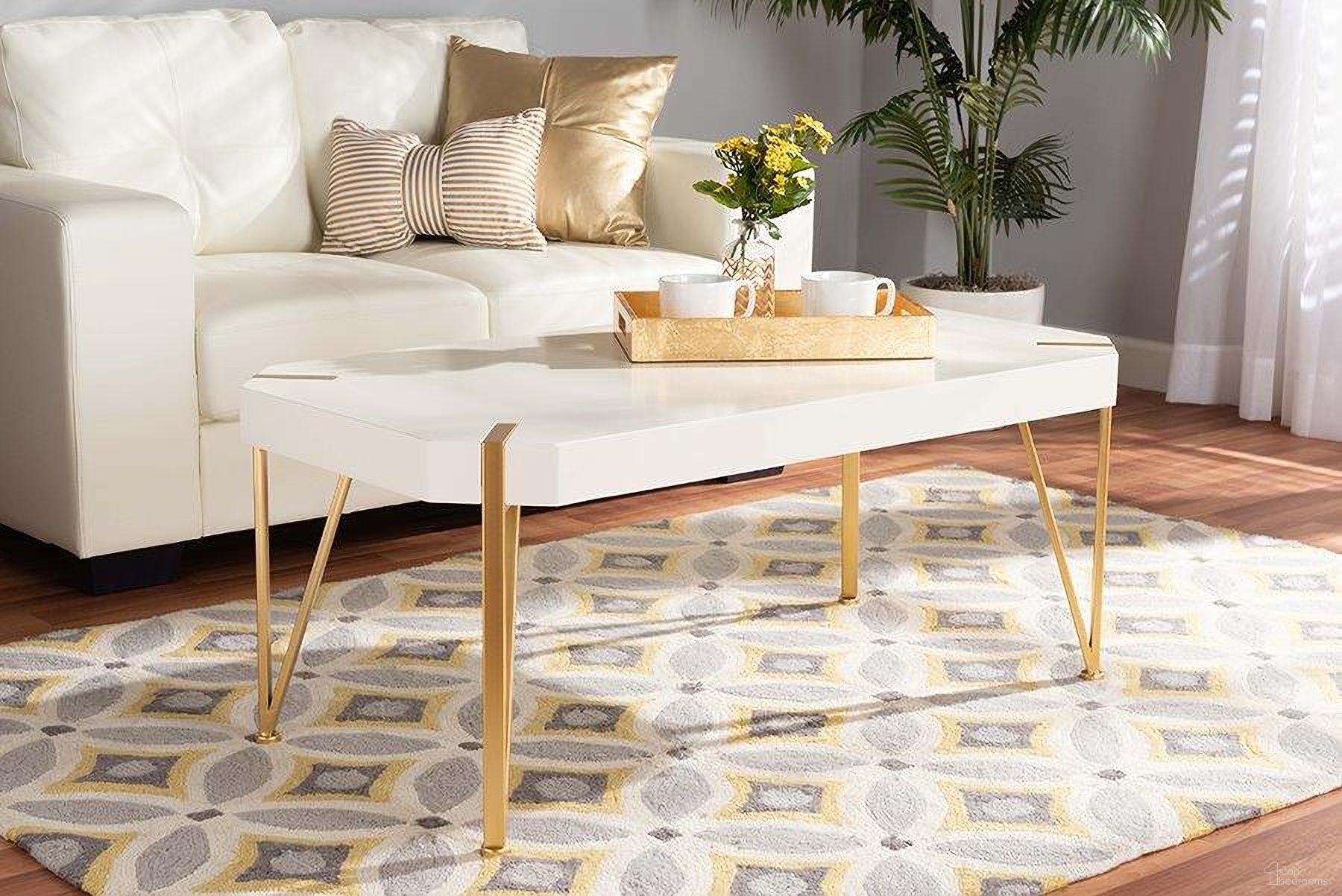 The appearance of Baxton Studio Kassa Contemporary Glam and Luxe Brushed Gold Metal and White Finished Wood Coffee Table designed by Baxton Studio in the glam interior design. This white and gold piece of furniture was selected by 1StopBedrooms from Kassa Collection to add a touch of cosiness and style into your home. Sku: JY20A156-White/Gold-CT. Material: MDF.