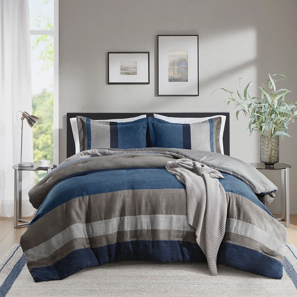 The appearance of Boulder Stripe Pieced Faux Suede Comforter Set In Blue designed by Olliix in the modern / contemporary interior design. This blue piece of furniture was selected by 1StopBedrooms from Boulder Stripe Collection to add a touch of cosiness and style into your home. Sku: AM10-0026. Material: Polyester. Bed Size: Full.