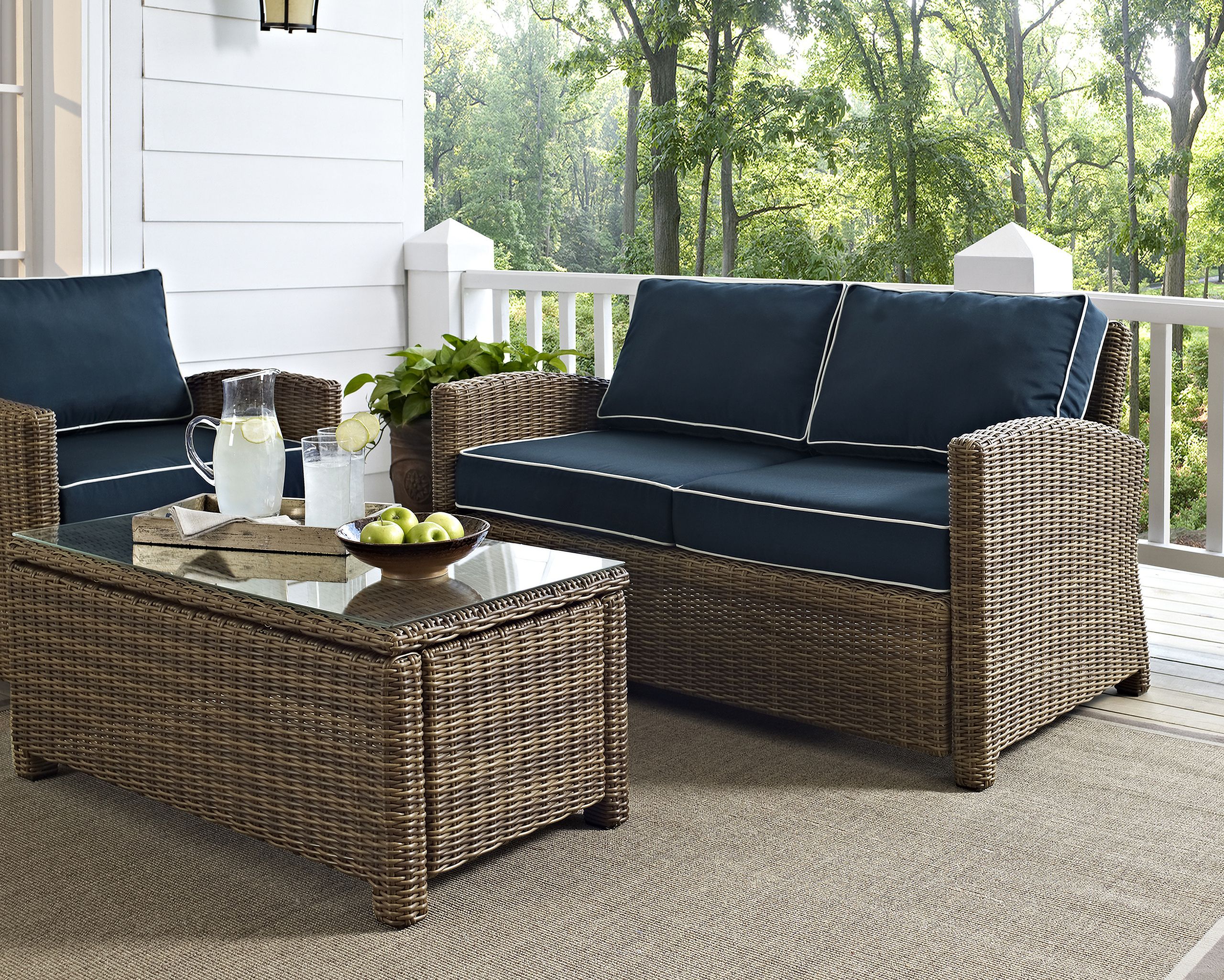 The appearance of Bradenton Wicker Outdoor Loveseat In Navy and Weathered Brown designed by Crosley Brands in the traditional interior design. This navy piece of furniture was selected by 1StopBedrooms from Bradenton Collection to add a touch of cosiness and style into your home. Sku: CO7115-WB;MO7499-NV. Material: Polyester.